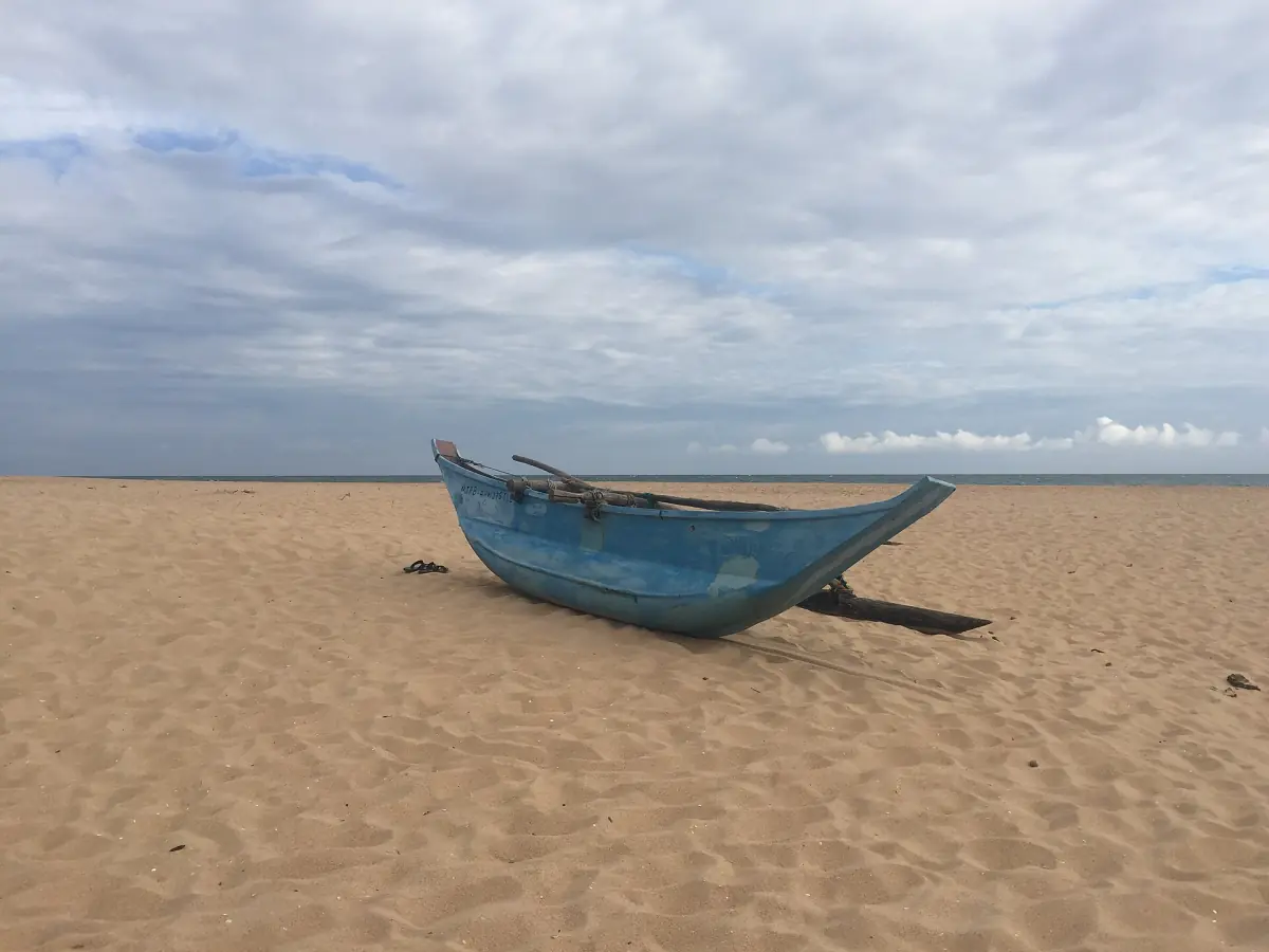 A wooden fishing boat on the sand at Hambantota