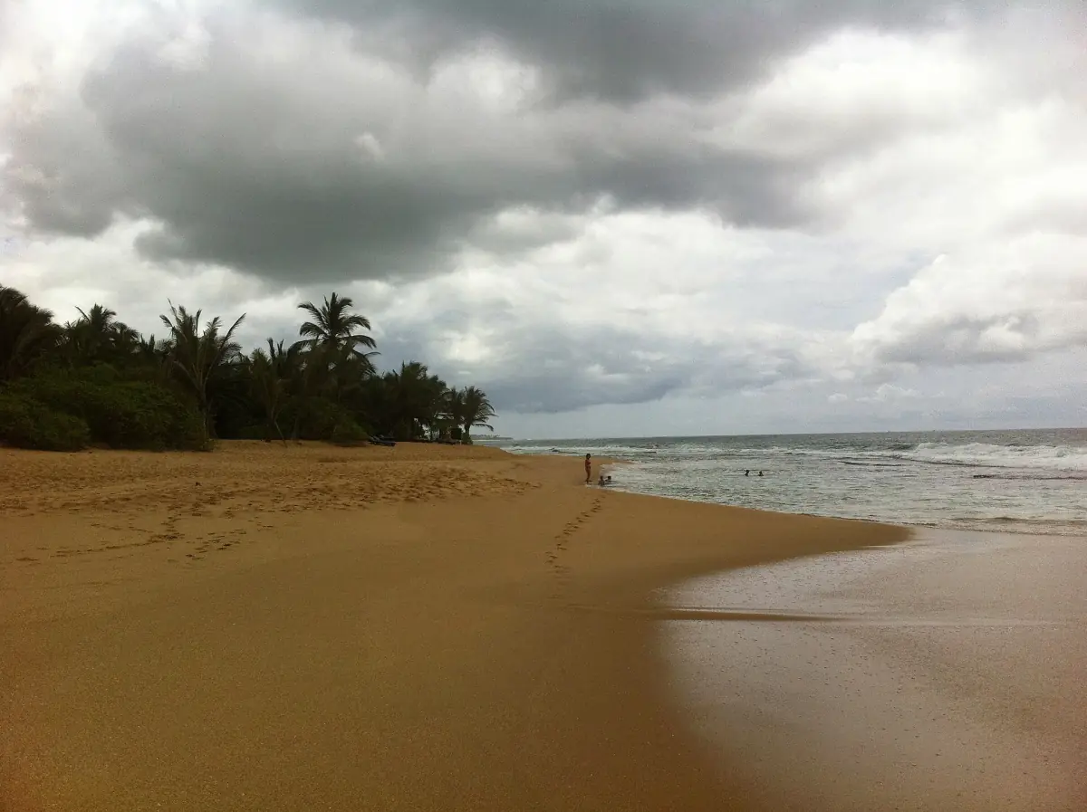 The sandy beach at Hambantota under a cloudy sky